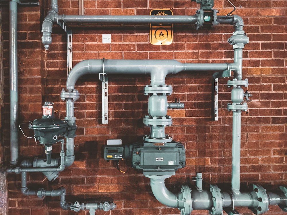 Installed pipework and valves on a building services wall