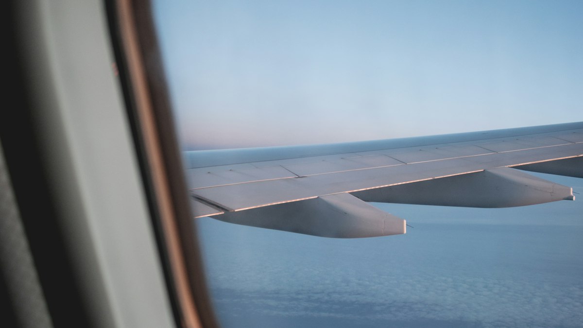 View of an aircraft wing above the clouds